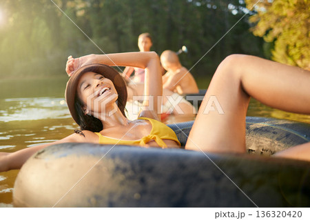 Lake, tube or happy girl in nature to relax with carefree fun, peace or adventure weekend in summer. Smile, break or young woman in river water or dam to float outdoors on holiday or vacation trip Lake, tube or happy girl in nature to relax with carefree fun, peace or adventure weekend in summer. Smile, break or young woman in river water or dam to float outdoors on holiday or vacation trip 136320420