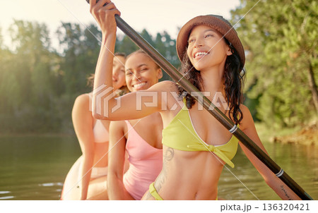 Girl friends, river and paddle on board with smile, adventure and workout in summer sunshine on holiday. Young women, water and together with rowing, bikini or health on camp vacation, lake or forest Girl friends, river and paddle on board with smile, adventure and workout in summer sunshine on holiday. Young women, water and together with rowing, bikini or health on camp vacation, lake or forest 136320421