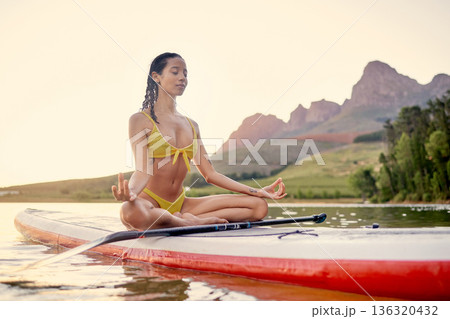 Yoga, surfboard and woman meditation on ocean, fitness and wellness or spiritual, peace and calm in bikini. Surfing board, balance and person meditate, lotus hands and holistic training in nature Yoga, surfboard and woman meditation on ocean, fitness and wellness or spiritual, peace and calm in bikini. Surfing board, balance and person meditate, lotus hands and holistic training in nature 136320432