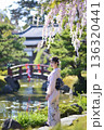 桜と共に日本庭園の静けさを楽しむ着物を着た日本人女性 136320441