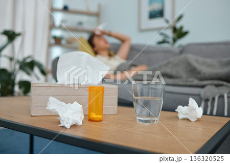 Pills, tissue and glass on table, living room or sick woman laying on sofa with stress, pain or frustrated. Girl, allergies or medical problem with water, medicine or fatigue on lounge couch in home Pills, tissue and glass on table, living room or sick woman laying on sofa with stress, pain or frustrated. Girl, allergies or medical problem with water, medicine or fatigue on lounge couch in home 136320525