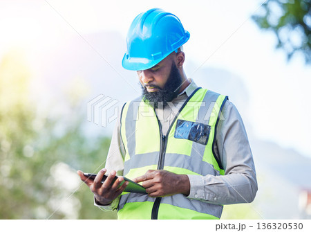 Construction worker, tablet and building inspection check with industrial employee with tech. African male person, professional and builder research with website and app for engineer project outdoor Construction worker, tablet and building inspection check with industrial employee with tech. African male person, professional and builder research with website and app for engineer project outdoor 136320530