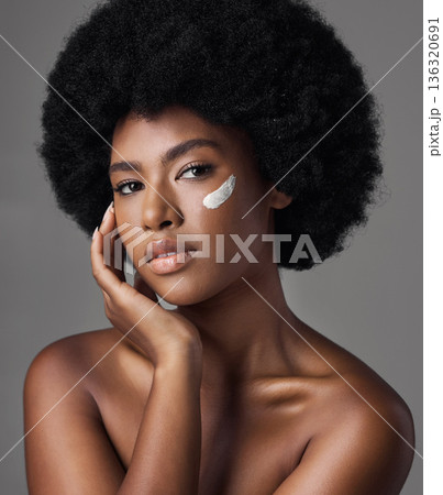 Black woman in portrait, cream and beauty with skincare and cosmetics product on studio background. Natural, afro hairstyle and African female model, dermatology with lotion and facial moisturizer 136320691