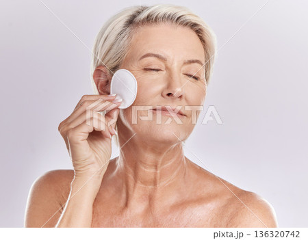 Senior woman, beauty and eyes closed, cotton pad and natural cosmetics with antiaging skincare on white background. Clean makeup from face, wellness and skin, female model with glow and dermatology Senior woman, beauty and eyes closed, cotton pad and natural cosmetics with antiaging skincare on white background. Clean makeup from face, wellness and skin, female model with glow and dermatology 136320742