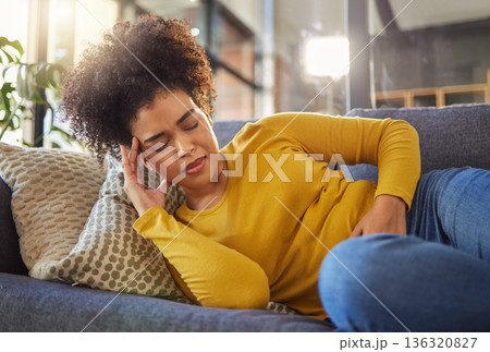 Stomach pain, digestion and menstruation with woman on sofa for healthcare, endometriosis and tired. Sick, medical and constipation with person in living room at home for nausea, virus and fear Stomach pain, digestion and menstruation with woman on sofa for healthcare, endometriosis and tired. Sick, medical and constipation with person in living room at home for nausea, virus and fear 136320827
