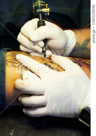 Creative, art and tattoo with closeup of person and machine in store for ink graphic, culture and drawing. Design, punk and identity with hand of artist in salon for picture, painting and pattern 136320840