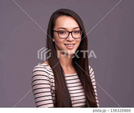 Portrait, fashion glasses and happy woman in studio isolated on a gray background mockup space. Face, nerd and female geek, person or model from Canada with trendy clothes, eyewear and casual style. Portrait, fashion glasses and happy woman in studio isolated on a gray background mockup space. Face, nerd and female geek, person or model from Canada with trendy clothes, eyewear and casual style. 136320860