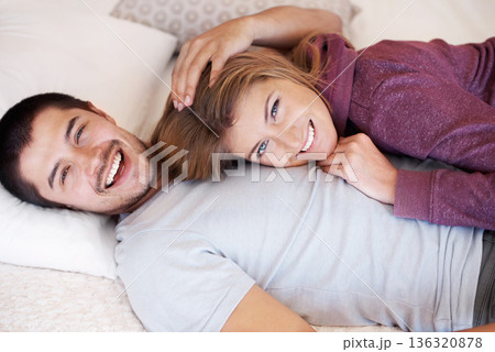 Love, portrait and happy couple on bed from above to relax, bonding and spending quality time together in home. Relationship, man and woman in bedroom with romance, embrace and smile in apartment. 136320878