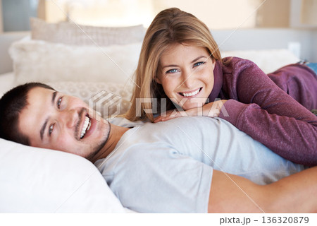 Love, marriage and portrait of happy couple on bed to relax, bonding and spending quality time together in home. Relationship, man and woman in bedroom with romance, embrace and smile in apartment. 136320879
