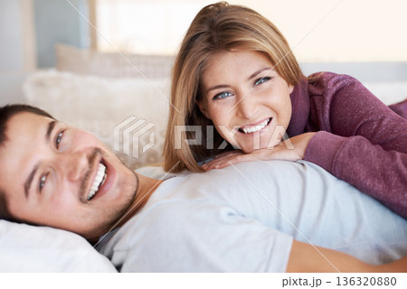 Love, smile and portrait of couple on bed to relax, bonding and spending quality time together in home. Relationship, happy man and woman in bedroom with romance, embrace and care in apartment in USA 136320880