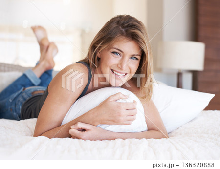 Portrait, relax and woman on a bedroom, pillow and happiness with peace, morning and comfortable. Face, female person or girl on a bed, home or rest with wellness, calm or chilling on a weekend break 136320888