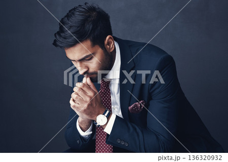 Business, thinking or Indian man with anxiety, fail or consultant against a dark studio background. Male person, employee or agent with stress, mistake or financial report with depression or confused 136320932