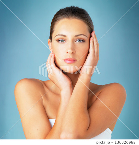 Skincare, cosmetics and beauty, portrait of woman with dermatology and makeup on blue background. Shine, skin care and wellness, fresh face of model with beauty and facial glow on studio backdrop. Skincare, cosmetics and beauty, portrait of woman with dermatology and makeup on blue background. Shine, skin care and wellness, fresh face of model with beauty and facial glow on studio backdrop. 136320968