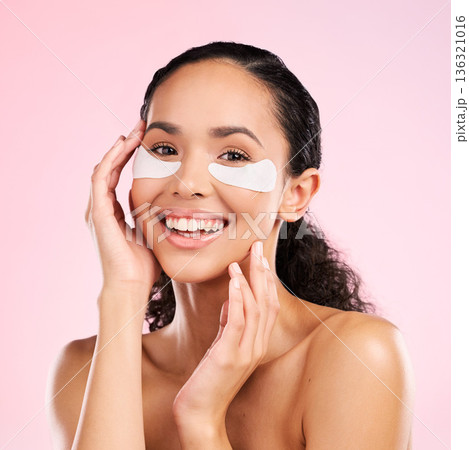 Face mask, eye patch and beauty of a woman with natural skin glow on a pink background. Dermatology, collagen and cosmetics portrait of female model for facial shine, wellness or self care in studio 136321016