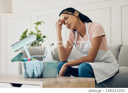 Tired, exhausted and woman cleaning a house with supplies, chemical or tools. Young female or cleaner in a clean lounge with headache or stress at an apartment or room with fatigue or problem 136321203
