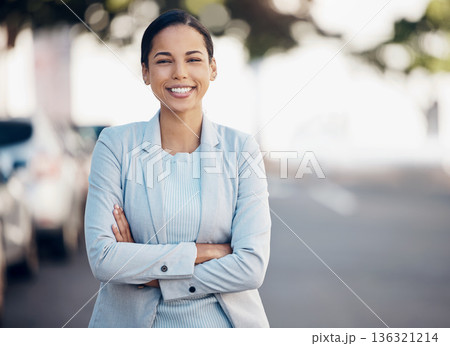 Business woman, arms crossed and confidence portrait in a city with a smile from worker. Young female person, professional and urban commute with travel and happy employee on a street with bokeh 136321214