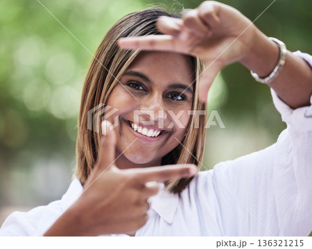 Portrait, smile and finger frame with a woman in nature, outdoor on a green background for creative photography. Face, photograph and hands with a happy young person in a park for a profile picture 136321215