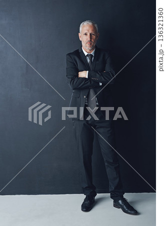 Portrait, serious and confident businessman with arms crossed in pride, lawyer or attorney on dark background. Boss, ceo and professional business owner, proud senior executive director at law firm. 136321360