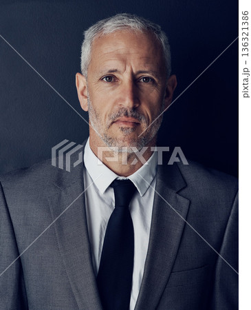 Portrait, management and mindset with a man CEO in studio on a dark background for leadership. Face, manager and corporate boss with a senior business man looking serious about his company mission Portrait, management and mindset with a man CEO in studio on a dark background for leadership. Face, manager and corporate boss with a senior business man looking serious about his company mission 136321386
