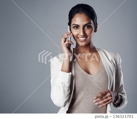 Phone call, smile and portrait of businesswoman in studio for communication, ideas and solution. Technology, cellphone and happy female lawyer on mobile conversation by gray background with mockup. 136321701