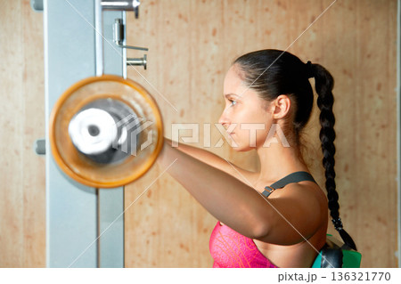 Profile, woman and barbell exercise in gym for power, workout and strong bodybuilding with focus. Serious female athlete, weights and fitness training for healthy muscles, sports and strength in club Profile, woman and barbell exercise in gym for power, workout and strong bodybuilding with focus. Serious female athlete, weights and fitness training for healthy muscles, sports and strength in club 136321770
