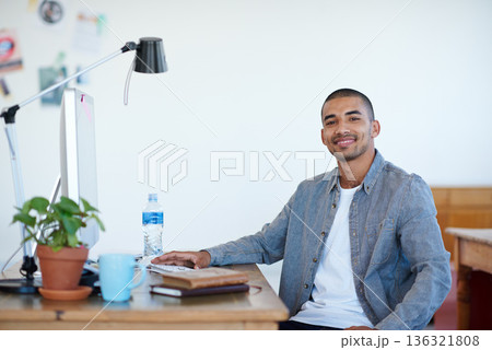 Professional man, portrait and smile at creative startup, confidence with pride in agency workplace. Confidence, success and career mindset, male person at desk with ambition at advertising firm 136321808