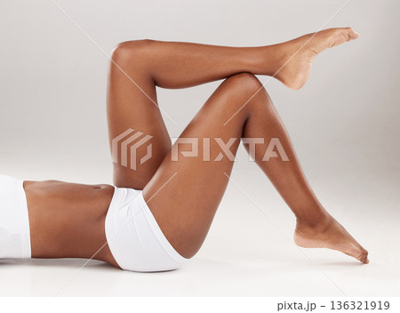Studio, skincare or relax person, legs or epilation results of cosmetic hair removal, spa hygiene routine or self care grooming. Floor, beauty salon waxing or model with soft skin on white background 136321919