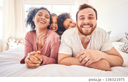 Portrait, happy family and relax on a bed, bond and having fun on the weekend in their home together. Interracial, love and face of playful children with parents in a bedroom, smile and playing games Portrait, happy family and relax on a bed, bond and having fun on the weekend in their home together. Interracial, love and face of playful children with parents in a bedroom, smile and playing games 136321975