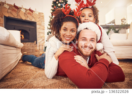 Christmas, happy family and portrait in home on floor, bonding and together. Xmas, smile and face of parents with girl, interracial and African mom with father for party, celebration and holiday Christmas, happy family and portrait in home on floor, bonding and together. Xmas, smile and face of parents with girl, interracial and African mom with father for party, celebration and holiday 136322026
