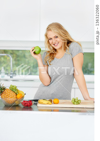 Fruits, apple or portrait of happy girl for healthy lunch or breakfast meal or diet in kitchen at home. Morning snack, smile or vegan woman eating fresh food to lose weight for wellness or gut health Fruits, apple or portrait of happy girl for healthy lunch or breakfast meal or diet in kitchen at home. Morning snack, smile or vegan woman eating fresh food to lose weight for wellness or gut health 136322060