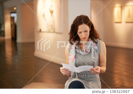 Museum, exhibition and a woman reading in a painting gallery while learning about creative culture. Brochure, information and a young female person at an art expo or exhibit for artistic photography 136322087