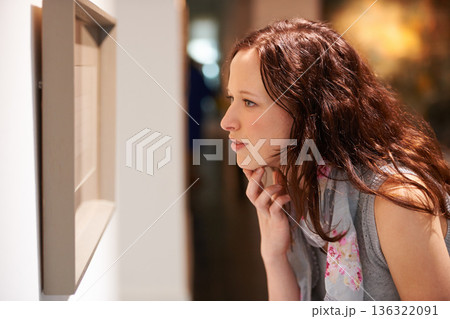 Gallery, woman and thinking at art exhibition, museum or study creative paintings on show in artist studio. Painting on wall, focus and girl studying abstract artwork, culture or buyer in Venice 136322091