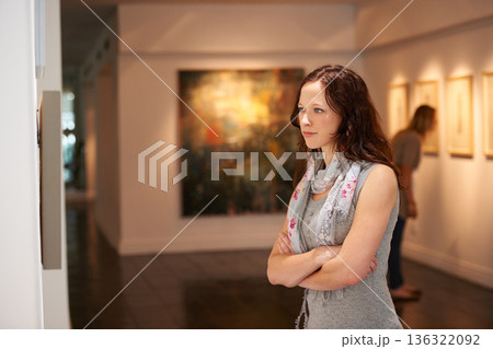Woman, gallery and thinking at art exhibition, museum or study creative paintings on show in artist studio. Painting on wall, focus and girl studying abstract artwork, culture or buyer in Venice Woman, gallery and thinking at art exhibition, museum or study creative paintings on show in artist studio. Painting on wall, focus and girl studying abstract artwork, culture or buyer in Venice 136322092