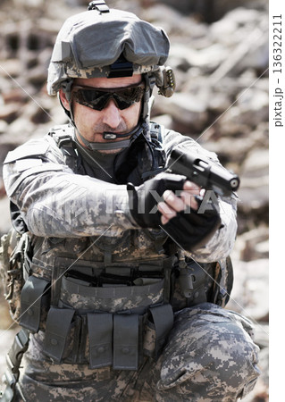 Soldier man, pistol and outdoor with aim, field or nature for war, fight or army in countryside. Military service, battlefield and agent with weapon, gear or helmet with focus for conflict in Ukraine 136322211