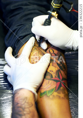 Arm, hands or tattoo artist drawing for body art, design and creativity in ink parlor shop for unique tattoos. Culture, closeup or creative designer holding a needle machine for tattooing a person Arm, hands or tattoo artist drawing for body art, design and creativity in ink parlor shop for unique tattoos. Culture, closeup or creative designer holding a needle machine for tattooing a person 136322215
