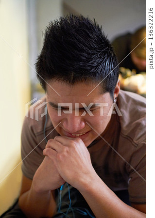 Pain, creativity and a man with a tattoo on body, hurt and sitting with an artist in a studio. Unhappy, frustrated and a young person with a painful experience and applying ink from a professional 136322216