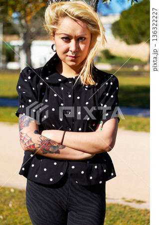 Tattoo, portrait and woman at park with arms crossed for stylish body art outdoor. Punk, confident or edgy young female person from Canada standing in cool clothes, trendy fashion or serious attitude Tattoo, portrait and woman at park with arms crossed for stylish body art outdoor. Punk, confident or edgy young female person from Canada standing in cool clothes, trendy fashion or serious attitude 136322227