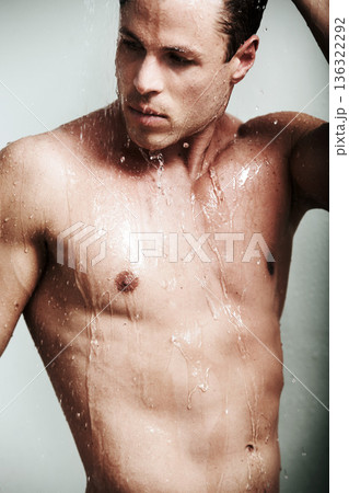 Sexy, shower and body of man with water for washing, cleaning and skincare or wellness. Seductive male model person posing for fitness, grooming and hygiene for clean or healthy skin with self care 136322292