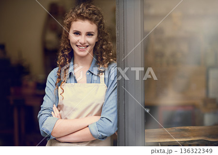 Smile, arms crossed and portrait of woman at restaurant for small business, coffee shop or waiter. Entrepreneur, happy and space with female barista at front door of cafe for diner in food industry Smile, arms crossed and portrait of woman at restaurant for small business, coffee shop or waiter. Entrepreneur, happy and space with female barista at front door of cafe for diner in food industry 136322349