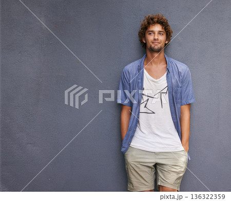 Confidence, casual and male model by a wall with mockup space with a hipster, cool and stylish outfit. Happy, positive and handsome man with trendy style or fashion by a gray background with mock up. Confidence, casual and male model by a wall with mockup space with a hipster, cool and stylish outfit. Happy, positive and handsome man with trendy style or fashion by a gray background with mock up. 136322359
