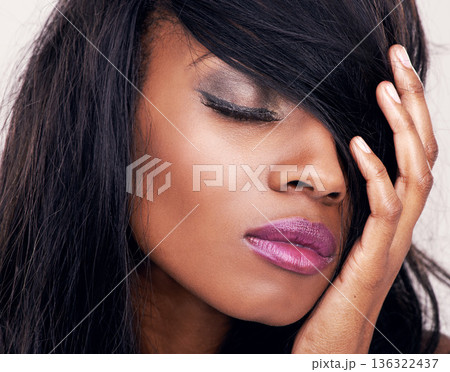 Hair, beauty and makeup on face of black woman in studio with wig and eyelashes . Headshot of african female model with hand for facial cosmetics, skin glow and lipstick shine for luxury aesthetic 136322437