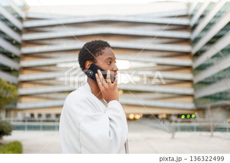 Young businesswoman talking on smartphone outside 136322499