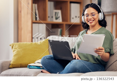 Laptop, documents and remote work with a freelance woman working online for a business startup. Computer, music and headphones with a happy young female entrepreneur reading information in her home Laptop, documents and remote work with a freelance woman working online for a business startup. Computer, music and headphones with a happy young female entrepreneur reading information in her home 136322543