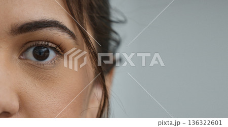 Woman, eye and zoom in portrait by space, mockup or health for vision, contact lens or biometric test. Girl, model and closeup for cybersecurity banner, retina or cornea scan for safety by background Woman, eye and zoom in portrait by space, mockup or health for vision, contact lens or biometric test. Girl, model and closeup for cybersecurity banner, retina or cornea scan for safety by background 136322601