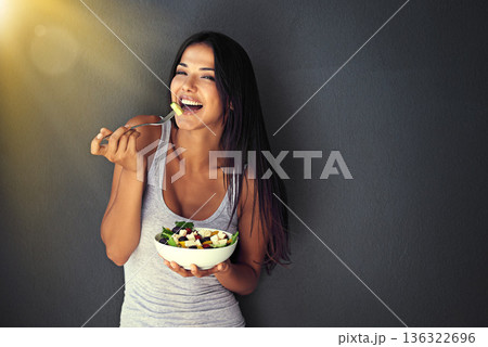 Happy woman is eating a salad, healthy food and nutrition, portrait and vegetables isolated on wall background. Organic, vegan and health with diet, female model to lose weight with mockup space Happy woman is eating a salad, healthy food and nutrition, portrait and vegetables isolated on wall background. Organic, vegan and health with diet, female model to lose weight with mockup space 136322696