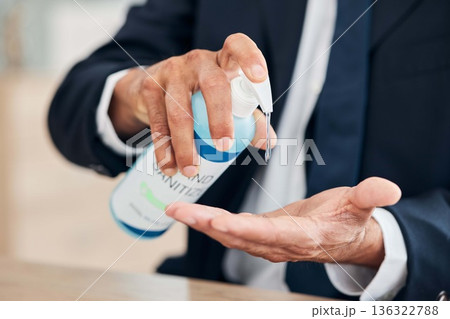 Hand sanitizer, business man and gel for hygiene, safety and bacteria at an office desk for wellness. Professional person with product for healthcare, cleaning and health or virus or germ protection 136322788