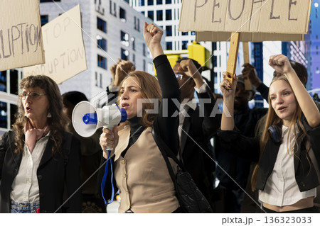 Activists taking part in a political protest near parliament building, raising awareness against corrupt politics, misconduct and scandalous government behavior. Democratic reform. Activists taking part in a political protest near parliament building, raising awareness against corrupt politics, misconduct and scandalous government behavior. Democratic reform. 136323033