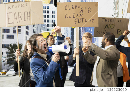 Multiethnic crowd of protesters marching for eco-friendly renewable energy, protecting the nature and planet Earth. Global warming campaign for conservation and sustainability. Multiethnic crowd of protesters marching for eco-friendly renewable energy, protecting the nature and planet Earth. Global warming campaign for conservation and sustainability. 136323060