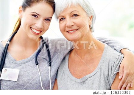Smile, portrait of caregiver and elderly woman in nursing home, trust and support with doctor. Retirement, healthcare service and face of nurse with patient, happiness and medical check in house. Smile, portrait of caregiver and elderly woman in nursing home, trust and support with doctor. Retirement, healthcare service and face of nurse with patient, happiness and medical check in house. 136323395
