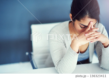 Business woman, stress and tired in office with hands, worried and anxiety at desk at startup. Young businesswoman, burnout and headache with anxiety, frustrated or financial crisis in workplace 136323411